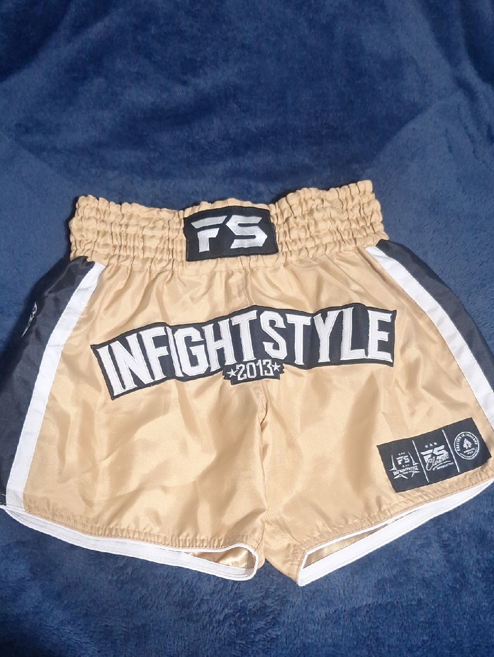 InFightStyle Gold Muay Thai Shorts with Black Logo Trim